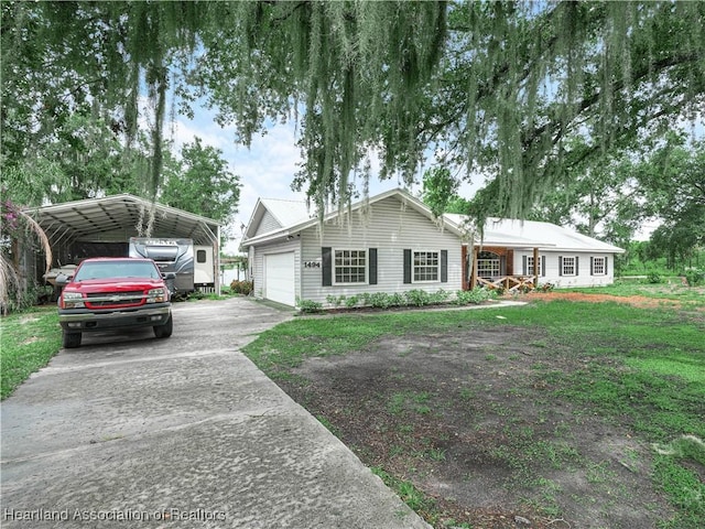 1494 Wilde St, Avon Park, FL 33825 - ranch-style house featuring a carport, driveway, a front yard, and a garage
