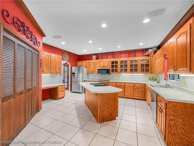 1494 Wilde St, Avon Park, FL 33825 - kitchen featuring appliances with stainless steel finishes, ornamental molding, light countertops, backsplash, and a center island