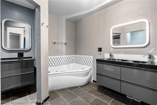 7343 Cortez Blvd, Sebring, FL 33872 - bathroom with a textured wall, a tub with jets, vanity, a textured ceiling, and tile patterned floors