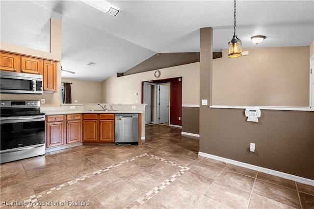 7343 Cortez Blvd, Sebring, FL 33872 - kitchen featuring stainless steel appliances, a sink, light countertops, vaulted ceiling, and brown cabinets