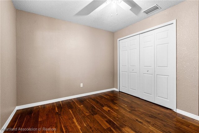 7343 Cortez Blvd, Sebring, FL 33872 - unfurnished bedroom with dark wood-style floors, baseboards, a closet, and ceiling fan