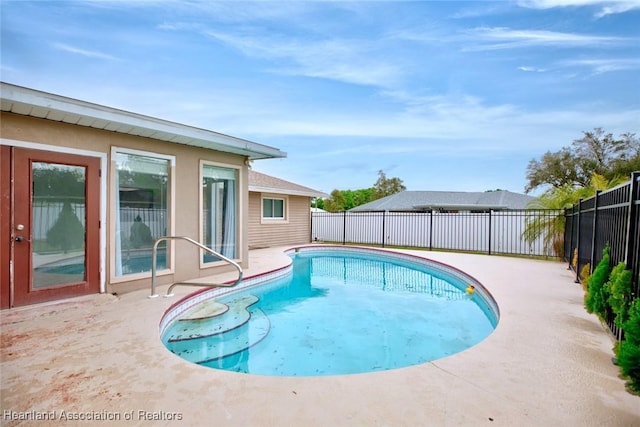 view of pool featuring a fenced backyard, a fenced in pool, and a patio