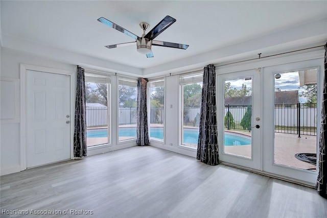 interior space with french doors, ceiling fan, and wood finished floors