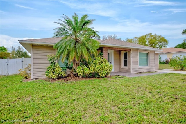 view of front of home featuring a gate, a front lawn, a patio area, and fence