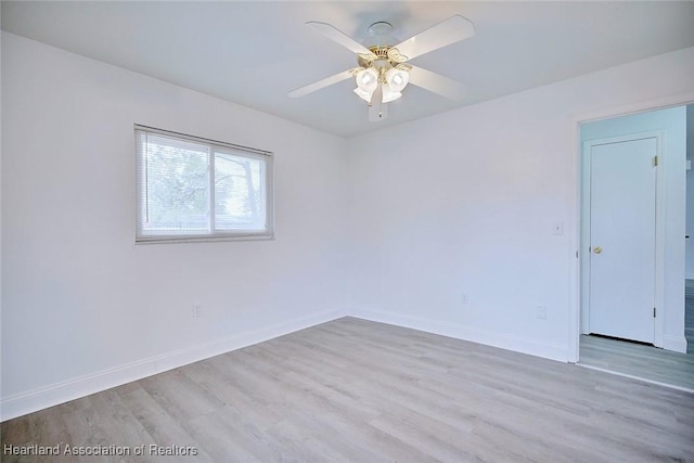 unfurnished room featuring a ceiling fan, baseboards, and wood finished floors