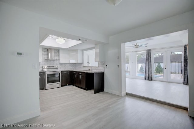 kitchen with french doors, baseboards, a sink, and electric stove