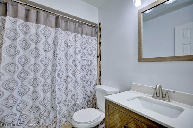 bathroom with vanity, toilet, and a shower with shower curtain