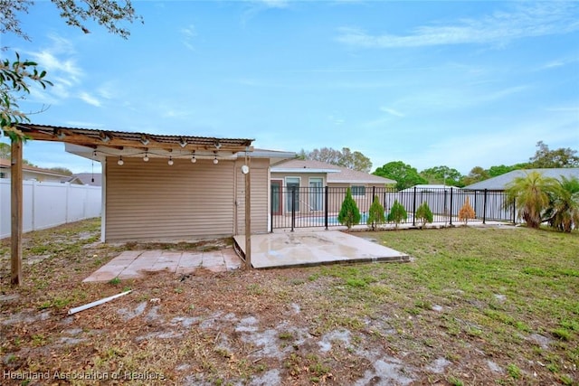 exterior space with a fenced backyard, a yard, and a patio area