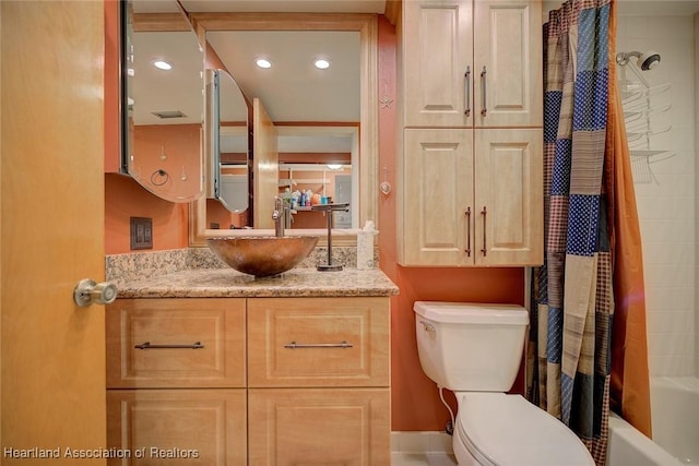 full bathroom with shower / bath combo, vanity, and toilet