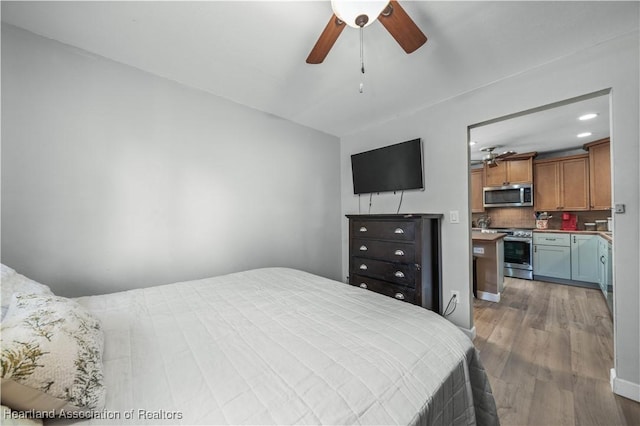 bedroom with ceiling fan and light hardwood / wood-style flooring