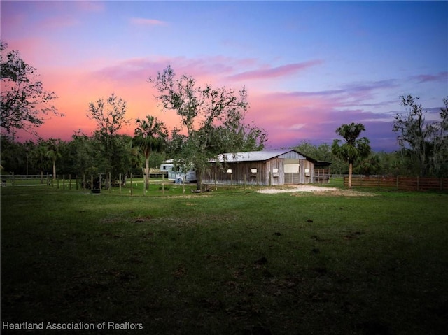 view of yard at dusk