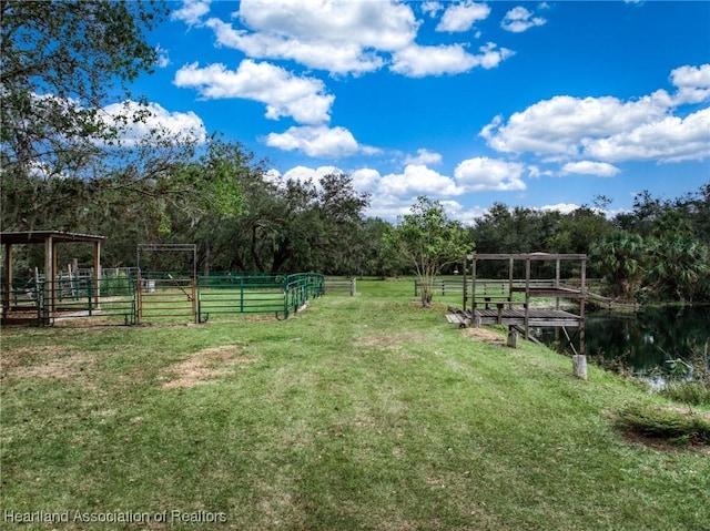 view of yard featuring a rural view and a water view