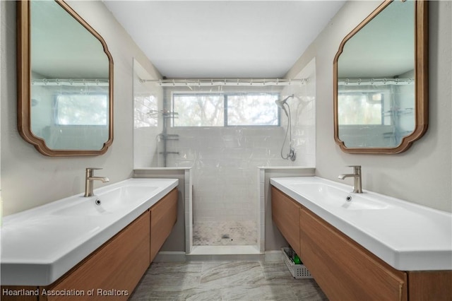 bathroom featuring a shower and vanity