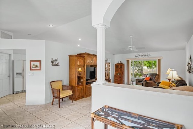 kitchen featuring light tile patterned floors, decorative columns, arched walkways, open floor plan, and white fridge with ice dispenser