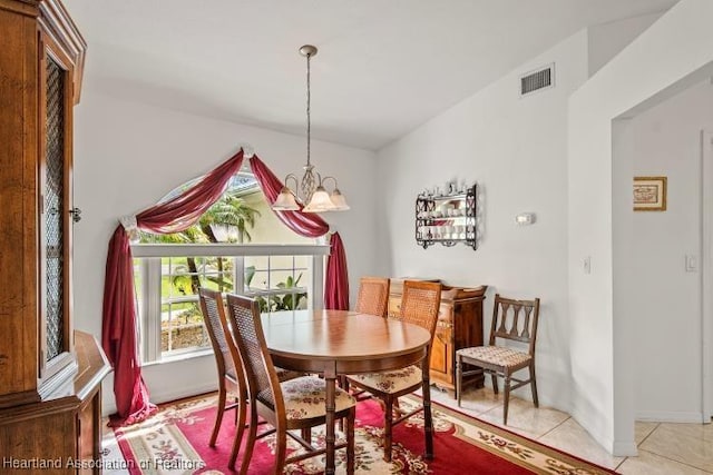 dining space with light tile patterned floors, visible vents, and a notable chandelier