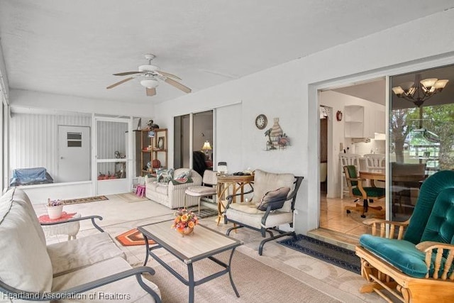 living room featuring ceiling fan with notable chandelier