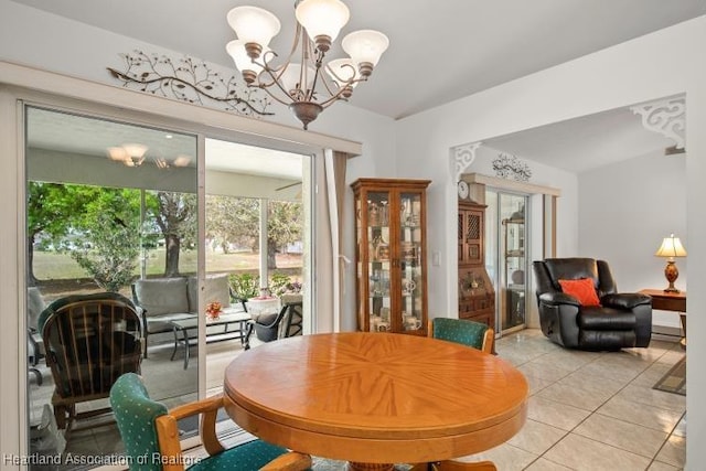 dining space featuring light tile patterned floors and an inviting chandelier