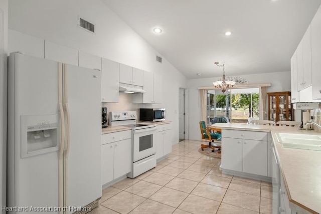 kitchen featuring white appliances, hanging light fixtures, light countertops, under cabinet range hood, and white cabinetry