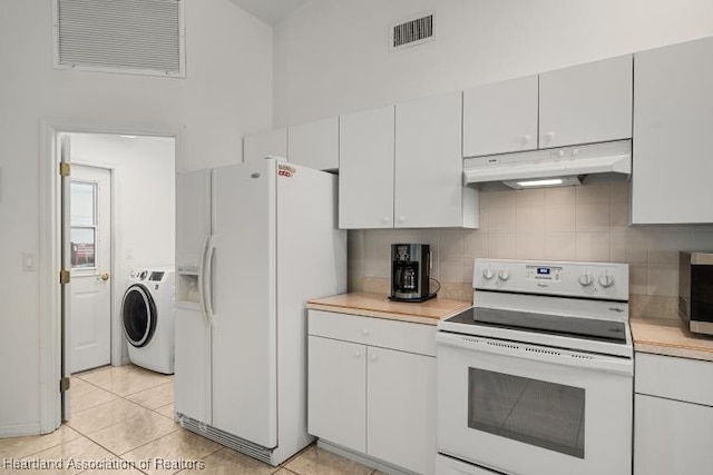 kitchen with light countertops, white appliances, washer / dryer, and under cabinet range hood