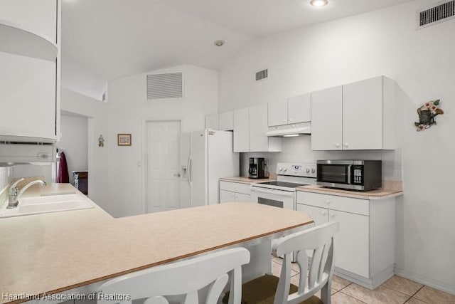 kitchen featuring white cabinets, white appliances, under cabinet range hood, and light countertops