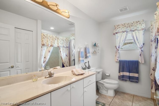 bathroom with toilet, vanity, visible vents, a closet, and tile patterned floors