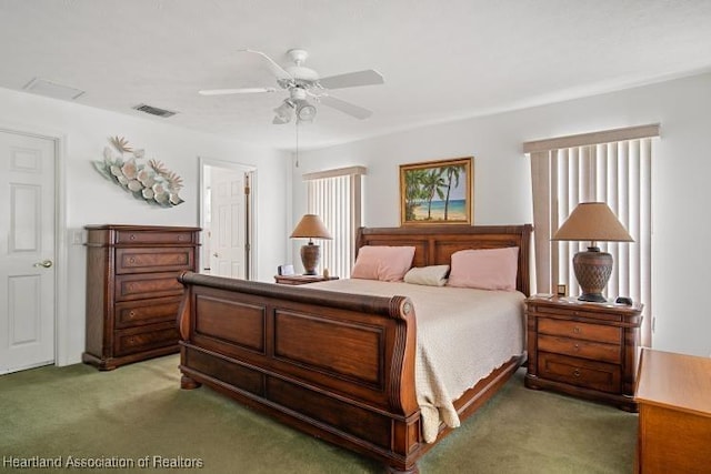 carpeted bedroom with a ceiling fan and visible vents