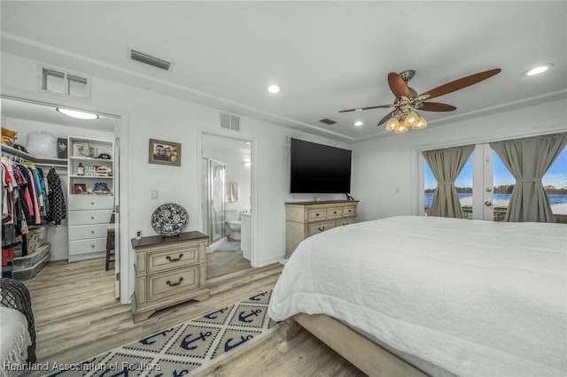 bedroom with visible vents, access to outside, a spacious closet, and light wood-style flooring