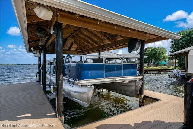 view of dock featuring boat lift and a water view