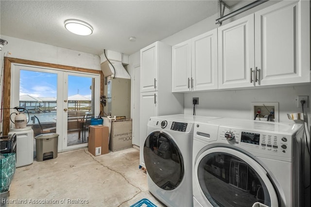 washroom with washing machine and dryer and cabinet space