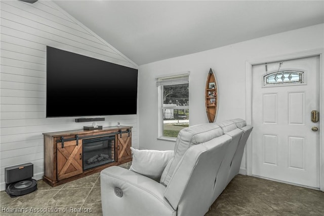 tiled living area with vaulted ceiling and wood walls