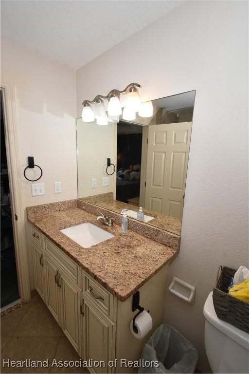 259 Condor Ave, Sebring, FL 33870 - bathroom featuring toilet, vanity, and tile patterned floors