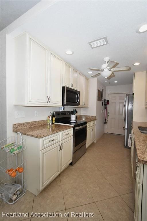 259 Condor Ave, Sebring, FL 33870 - kitchen with appliances with stainless steel finishes, light tile patterned floors, ceiling fan, recessed lighting, and light stone counters
