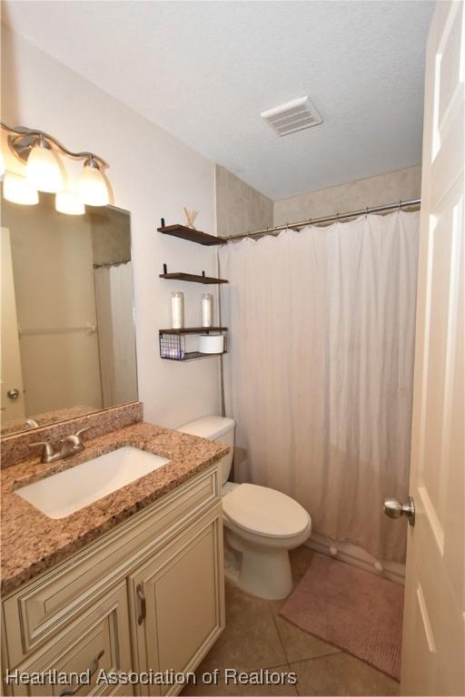259 Condor Ave, Sebring, FL 33870 - full bath featuring vanity, toilet, and tile patterned flooring