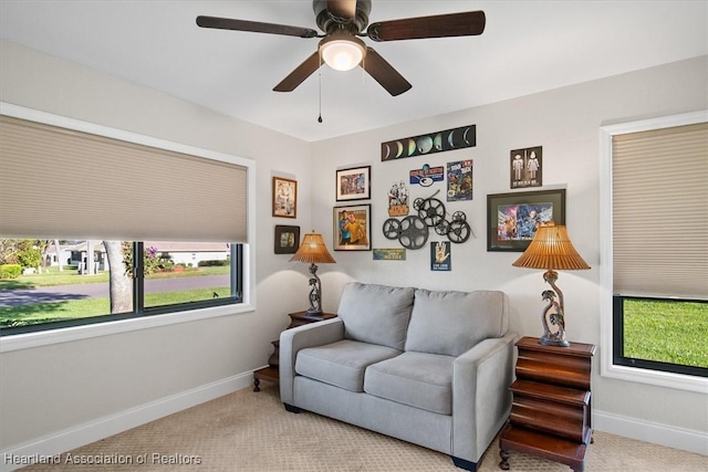 carpeted living room featuring ceiling fan