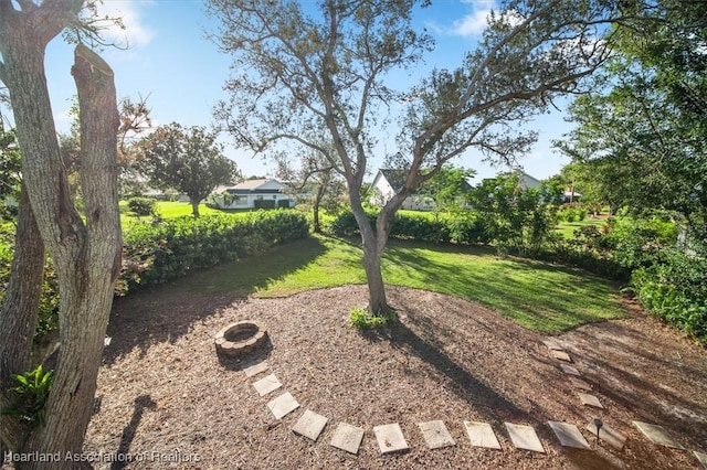 view of yard featuring an outdoor fire pit