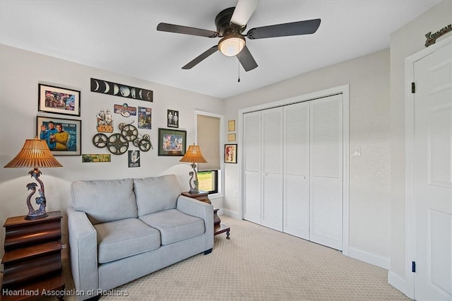 living room featuring light carpet and ceiling fan