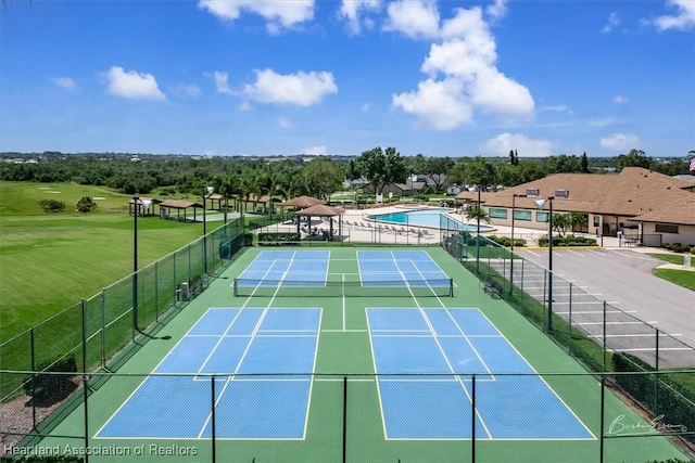 view of tennis court featuring a community pool