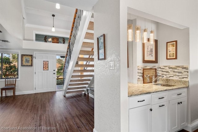 entryway featuring dark hardwood / wood-style floors, a wealth of natural light, and sink