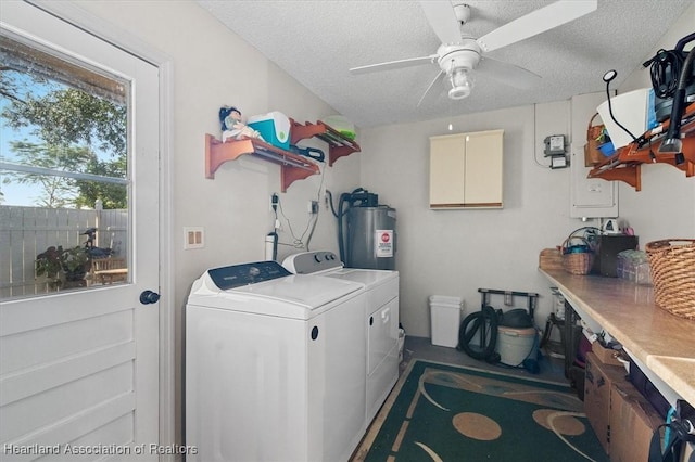 washroom with a textured ceiling, electric water heater, separate washer and dryer, and ceiling fan