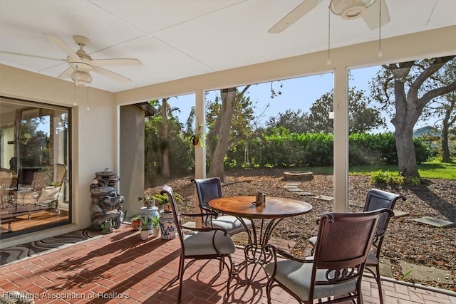 sunroom / solarium with a wealth of natural light and ceiling fan