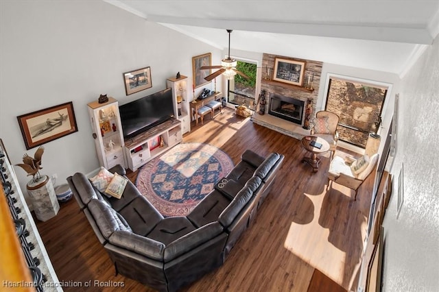 living room with ceiling fan, a fireplace, dark wood-type flooring, and lofted ceiling