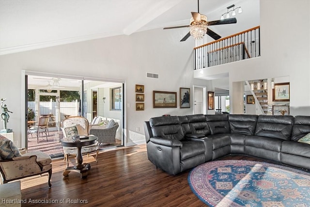 living room featuring a high ceiling, ceiling fan, ornamental molding, beamed ceiling, and wood-type flooring