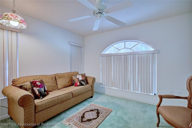 carpeted living room featuring ceiling fan