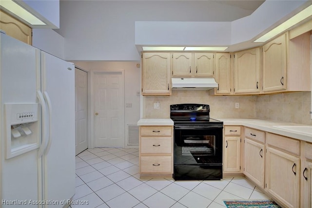 kitchen with light brown cabinetry, white refrigerator with ice dispenser, under cabinet range hood, black electric range, and light tile patterned floors
