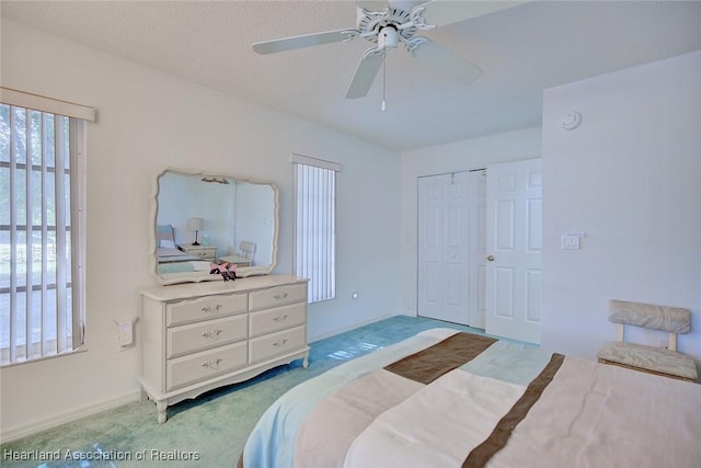 bedroom featuring carpet floors, baseboards, ceiling fan, and a closet