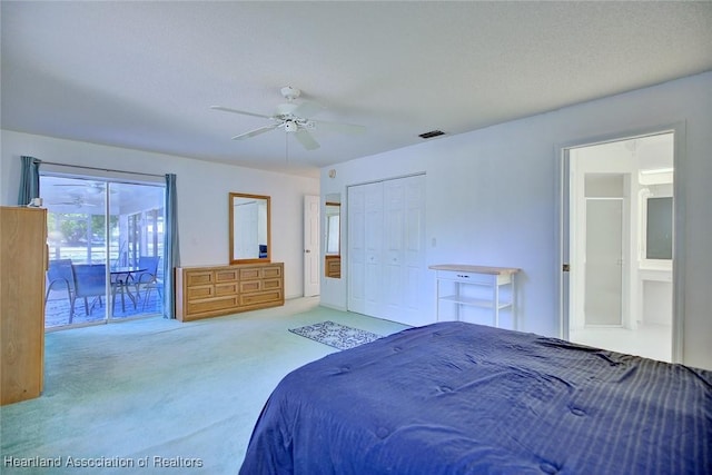 carpeted bedroom featuring a ceiling fan, visible vents, access to exterior, and a closet