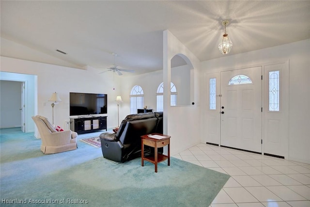entrance foyer with a healthy amount of sunlight, a ceiling fan, vaulted ceiling, and visible vents