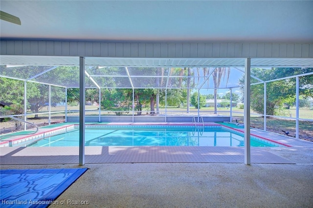 pool with a patio and glass enclosure