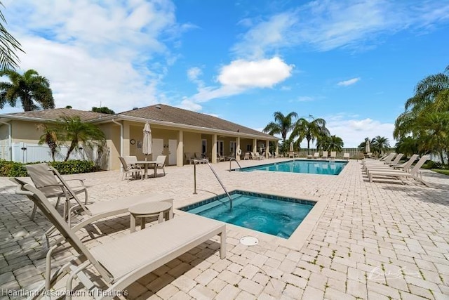 view of pool featuring a community hot tub and a patio