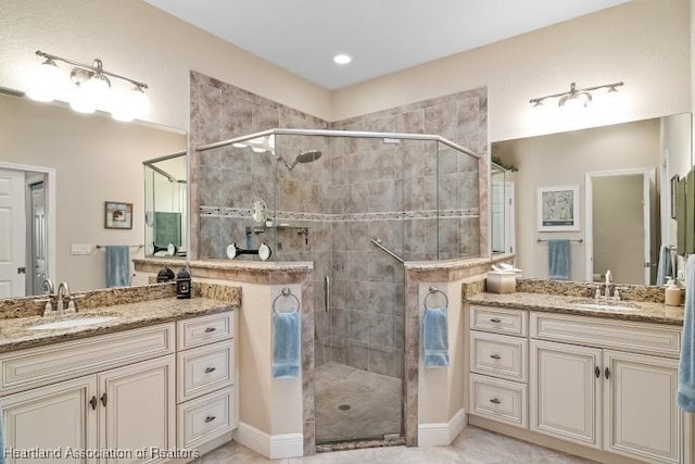 bathroom featuring vanity and a shower with shower door